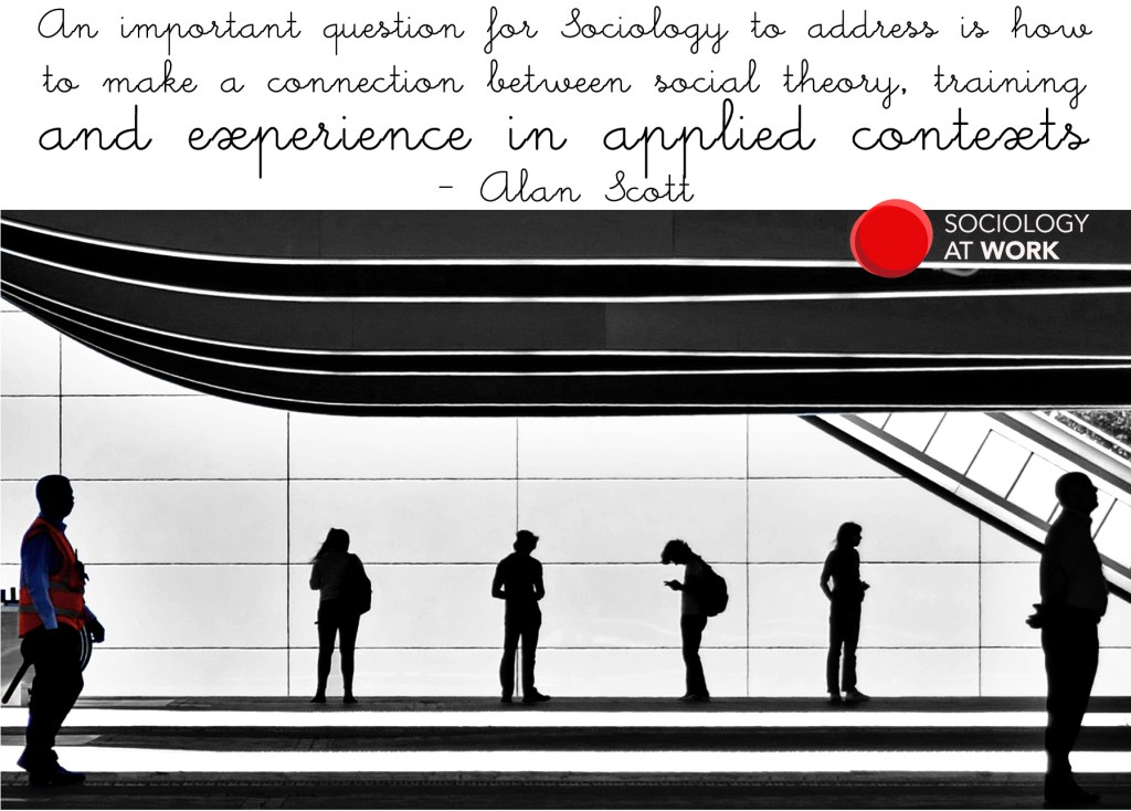 Silhouettes of people standing apart at a train station