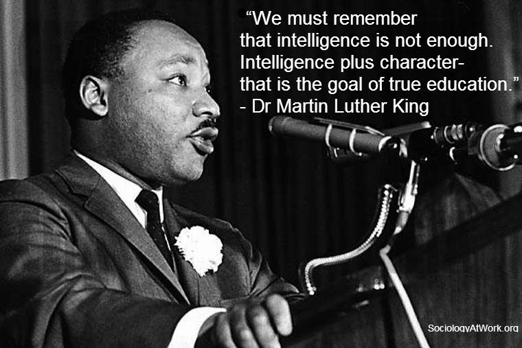 Dr Martin Luther King is a Black man with short dark hair. He wears a suit with a flower on his lapel. He is speaking at a podium. Quote reads: We must remember that intelligence is not enough. Intelligence plus character-that is the goal of true education. - Martin Luther King Jr