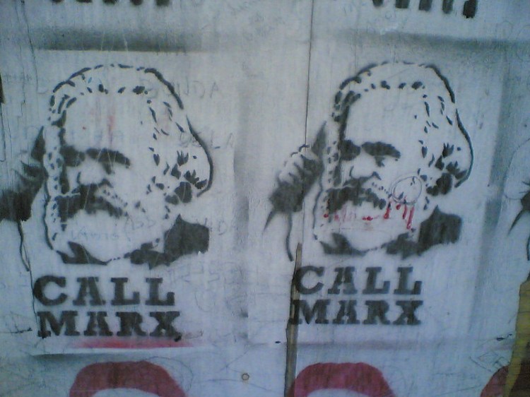 Street art showing Karl Marx on the phone, with the text: Call Marx