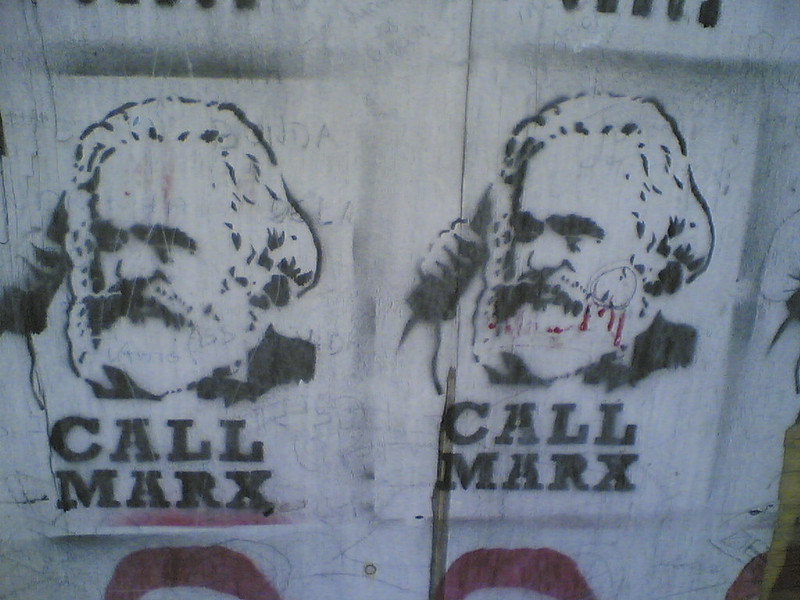 Street art showing Karl Marx on the phone, with the text: Call Marx