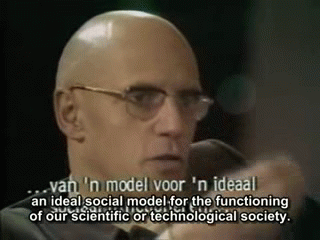 Foucault gestures emphatically with his hands