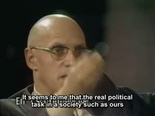 Foucault gestures emphatically with his hands