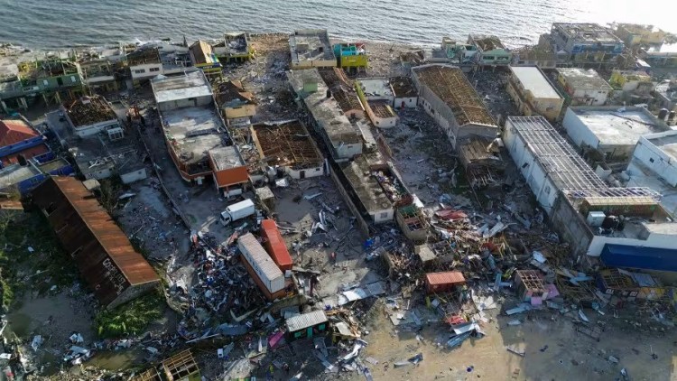 Aerial view of shattered buildings near the coast