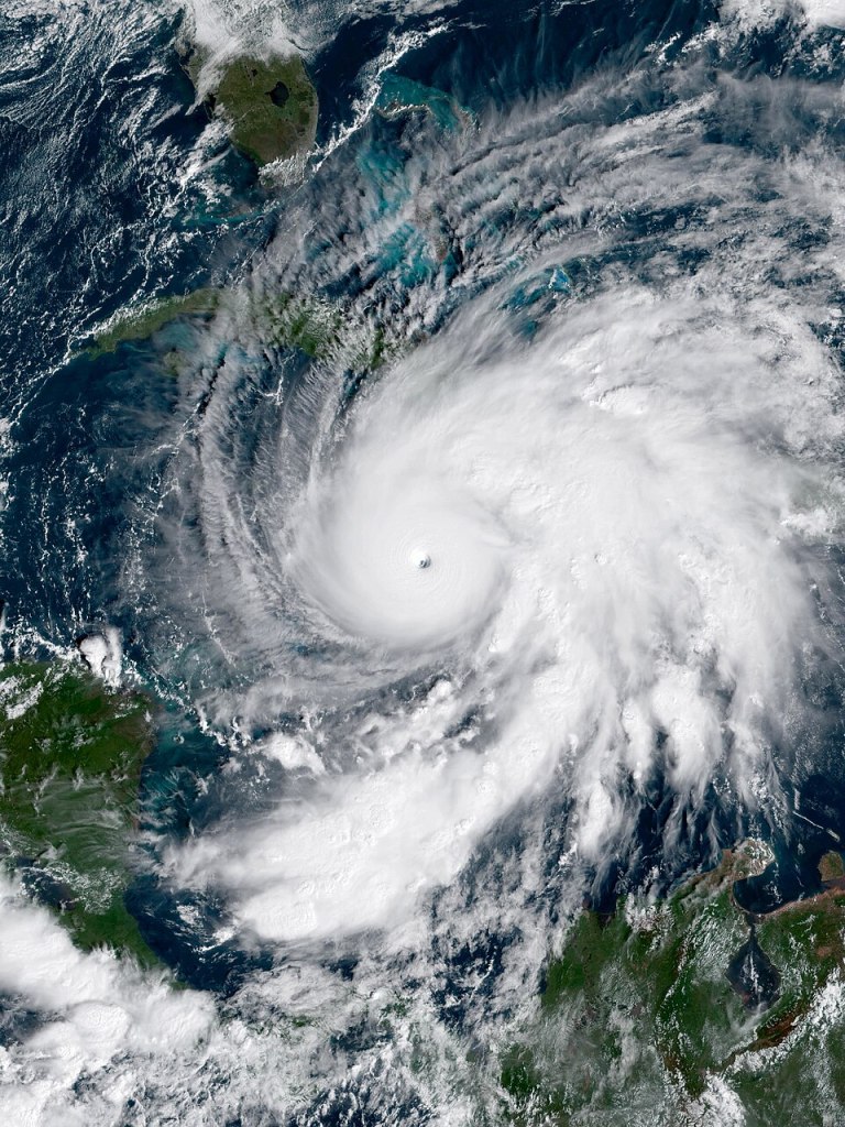 Satellite view of Hurricane Melissa, showing a massive cloud swirl over a rough sea
