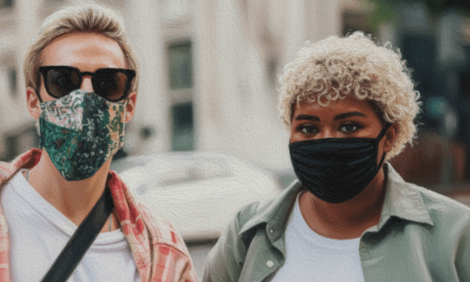 A Black woman and white man stand together wearing COVID-19 face masks