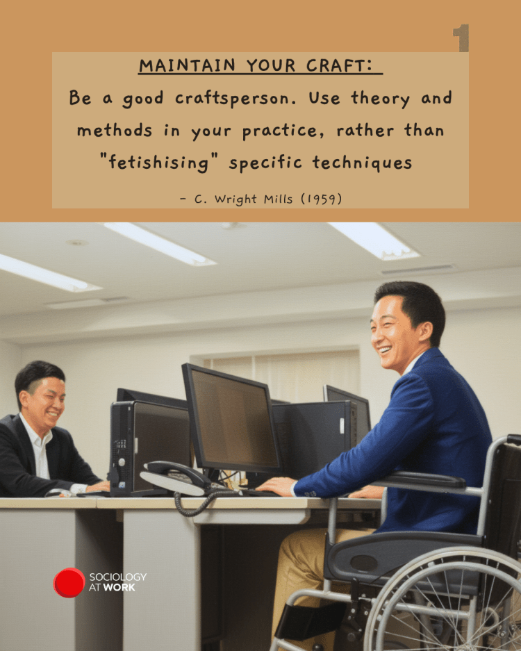 Two East Asian men laugh while sitting at their desks, one of them is in a wheelchair