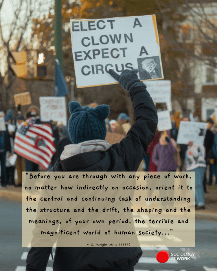 A woman wearing a coat, gloves, and beanie is seen from the back, holding a sign across the street from protesters. Her sign has a caricature of President Trump with the words: Elect a clown, expect a circus